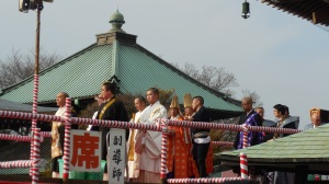 The priests leading the procession of people